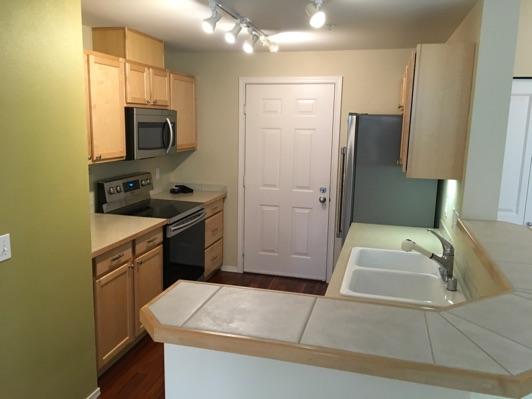 1. Kitchen Room Kitchen Walls and ceilings appear in good condition overall. Flooring is wood. Heat register present. Accessible outlets operate. Light fixture operates.