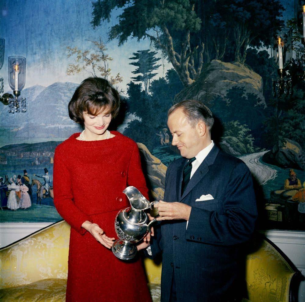 First Lady Jacqueline Kennedy accepts the donation of a silver pitcher from James Hoban Alexander,