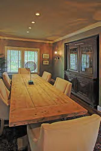 Spacious and elegant, the formal dining room has a custom antique pine timber dining table and grass cloth wall paper.