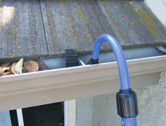 2) Pull the Paddle Brush back slightly and lift up and over gutter support.
