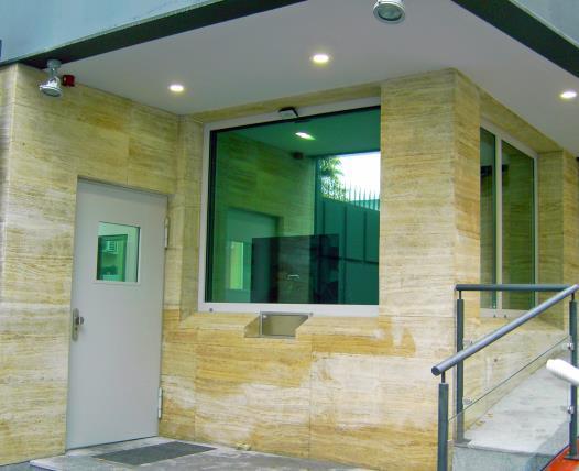 Photos from left to right: 1-leaf opaque steel door with vertical bar handle. 1- leaf glazed steel door in combination with a transaction window for the entrance of a German embassy.