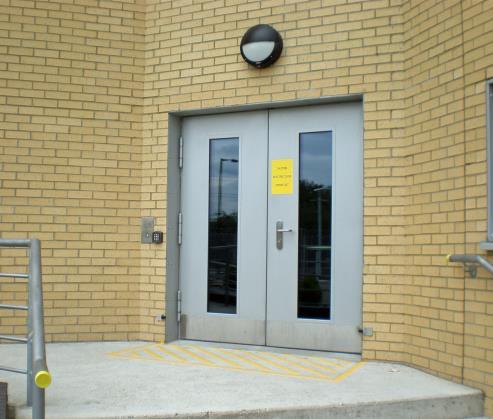 Photos from left to right: 2 glazed external doors at a prison. Glazed door clad with stainless steel for a radio station. Glazed external door for a police station.