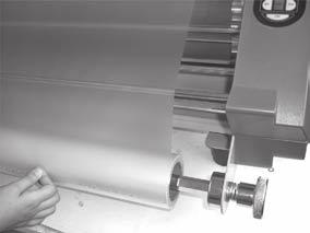 Then tighten the lower locking core screws. NOTE: If the film is not aligned properly exposed adhesive will adhere to the rollers and may cause the film to jam.