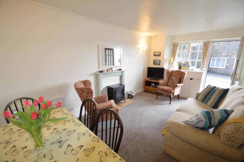 ACCOMMODATION COMPRISES COTTAGE ONE LIVING ROOM 5.20 m(17'1'') x 2.90 m(9'6'') Feature fireplace with electric log effect stove set on a stone hearth. Television point. Two wall light points.