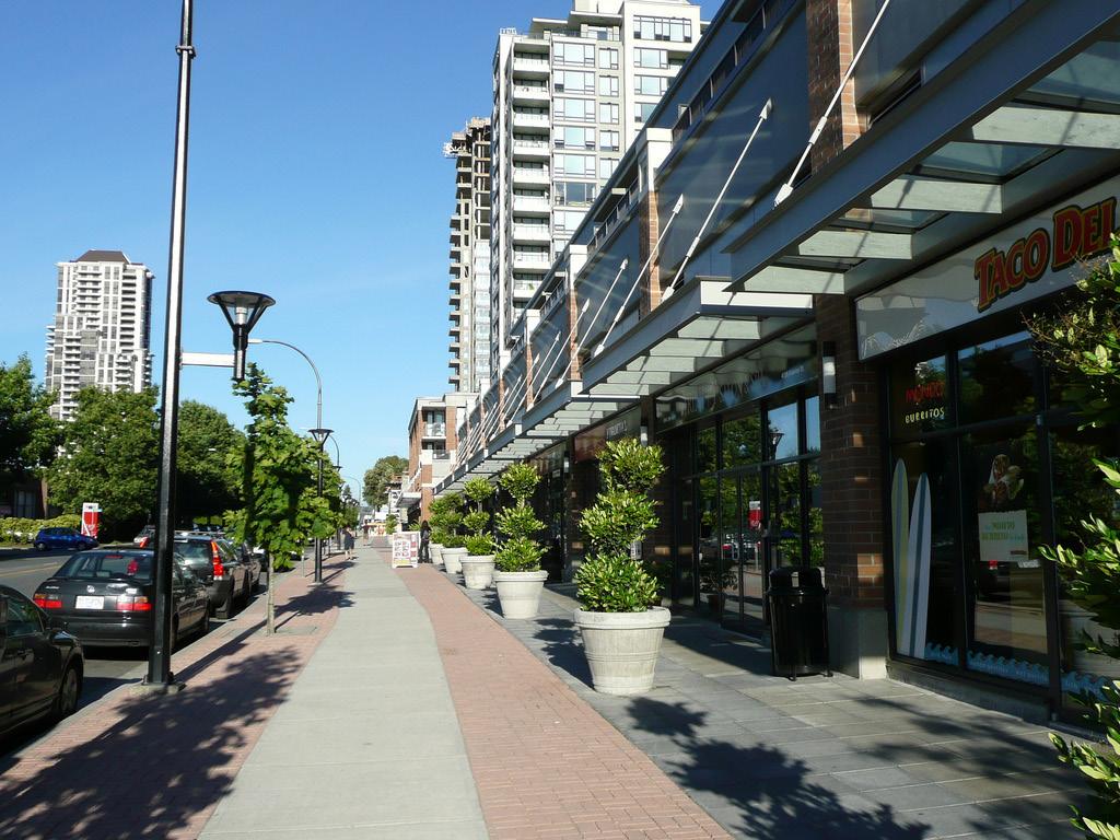 i. Large retail uses, such as supermarkets and pharmacies, are encouraged to incorporate the following urban design strategies to minimize their impact on the street-interface and create a fine