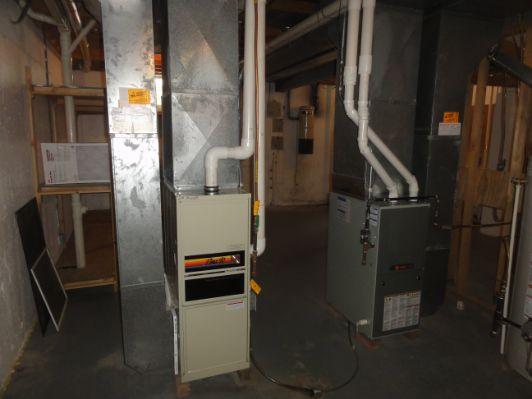 4. Heating Equipment and Air Handlers Both furnaces responded adequately to the call for heat. Age Over 20 years. Capacity 80,000 btu's. Manufacturer: Bryant Age 5 years. Capacity 80,000 btu's. Manufacturer: Trane 5.