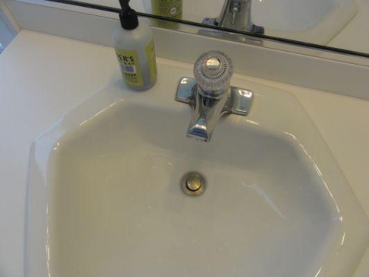 The bathroom sink faucet appeared to be in serviceable  The bathroom cabinets and counter