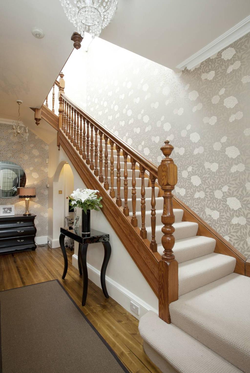staircase leading to the upper floor. The accommodation on the ground floor level comprises, Lounge with feature bay window, fire surround with tiled inset and open fire.