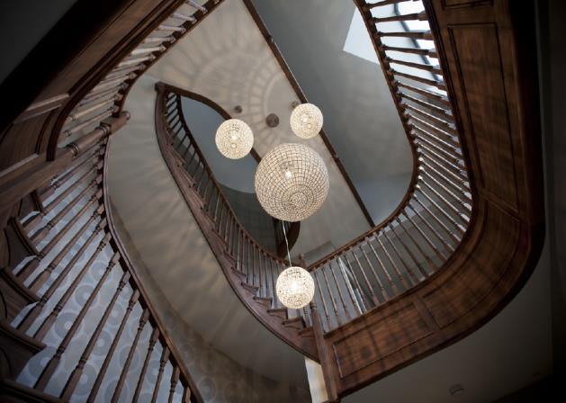 The Reception Hall has an immediate sense of of grandeur with a truly breathtaking American black walnut double height staircase with contemporary chandeliers.