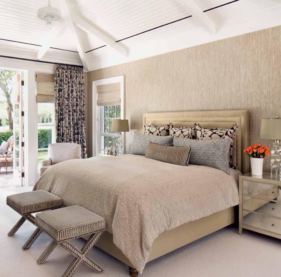 Layered pillows add extra comfort and style to the master suite s custom-built Patricia Edwards bed.