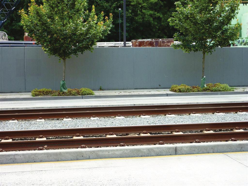 Ballasted track (track constructed on a gravel bed) can reduce noise levels through greater sound absorption compared to embedded track, sometimes called paved track, which is set into the street.