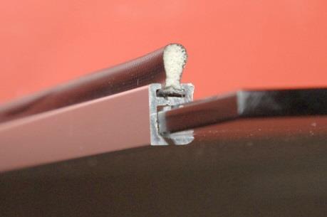 The seal slides into a groove in the door extrusion, and can be withdrawn and replaced, if damaged. A centre seal is fitted between the inner and outer doors.