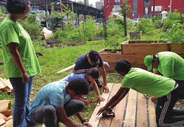 YLC volunteers building a compost bin at the Eagle Slope Commuity Garden in the Bronx.