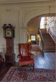 There are chairs available to sit on in the entrance hall, one with armrests. House 1. Wooden floors throughout the house are mainly carpeted, occasionally with mats too. 2.