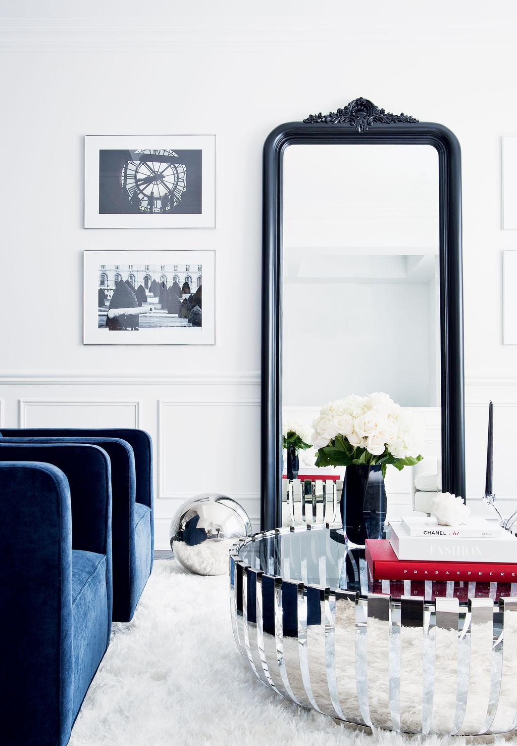 Juxtaposing hard and soft elements, such as the velvet armchairs and chrome and glass coffee table, gives the living room dimension. A chrome ball is a playful conversation piece.
