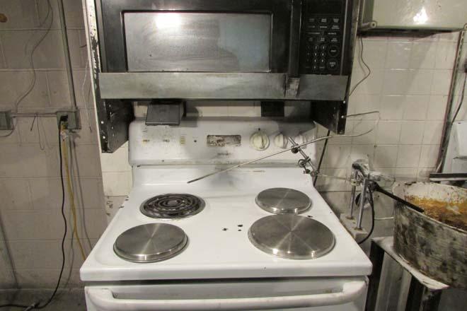 A residential microwave was positioned above the stove and the mounting height is
