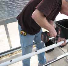 With assistance, snap a chalk line along the top, center of the pvc assembly to mark the drain hole positions from end-to-end.