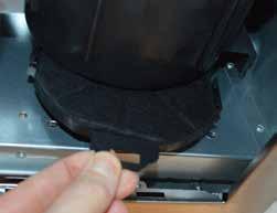 prevent damage from other items in the dishwasher. To remove the grease filter, push in the button on the handle and then pull down on the filter at the front as shown in figure 2.