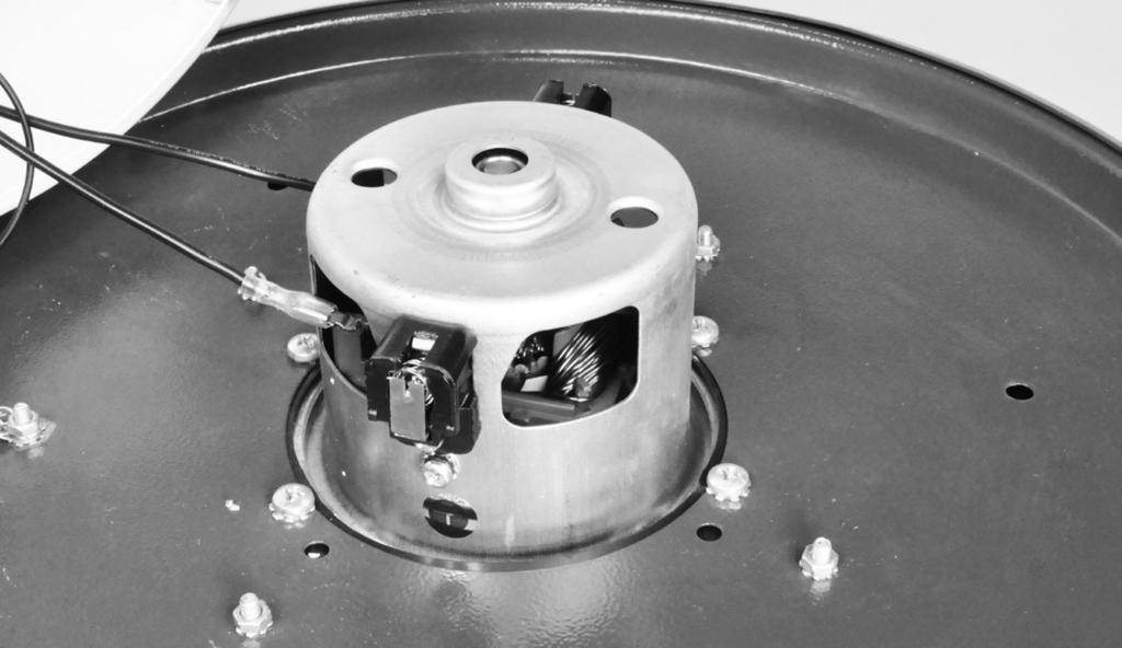 . Remove the motor cover from the top lid of the machine by unscrewing the three Phillipshead screws holding it in place.