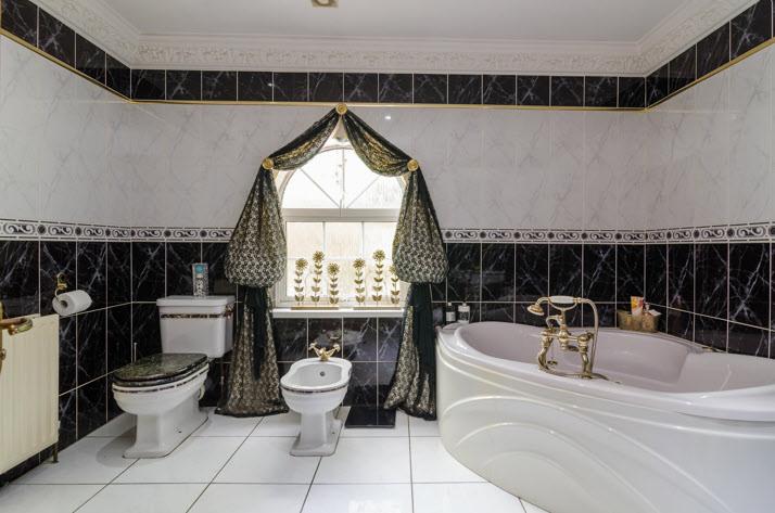 BATHROOM: White suite comprising corner panelled bath with multi jets, mixer tap, telephone hand shower,