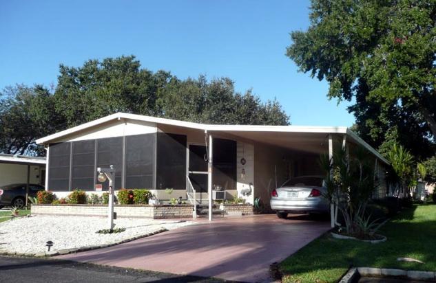 Large carport includes an overhead plant watering system and also has an arbor behind the shed. French doors lead from LR to a 10' x 22' lanai with vinyl windows and blinds.