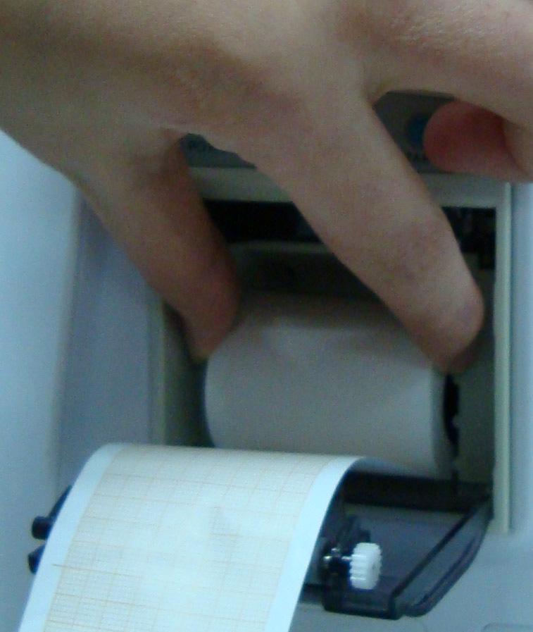 2. Insert a new roll of paper into the paper cassette, printing side facing upwards. 3.