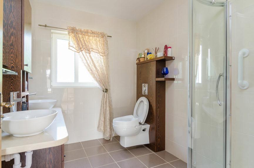 ENSUITE SHOWER ROOM: White suite comprising wc with solid wood frame, vanity unit with twin sinks