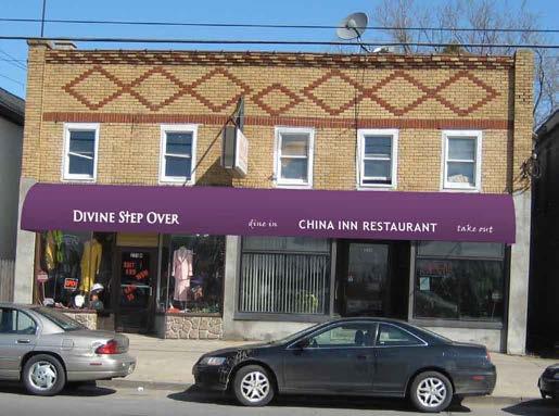 Two storefronts in a single building No awnings installed Sign band does not relate to the building form, materials or