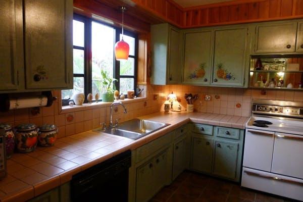 There is not enough clearance above the stove for safety purposes but also it does not stick within the kitchen triangle with the sink, stove and fridge.