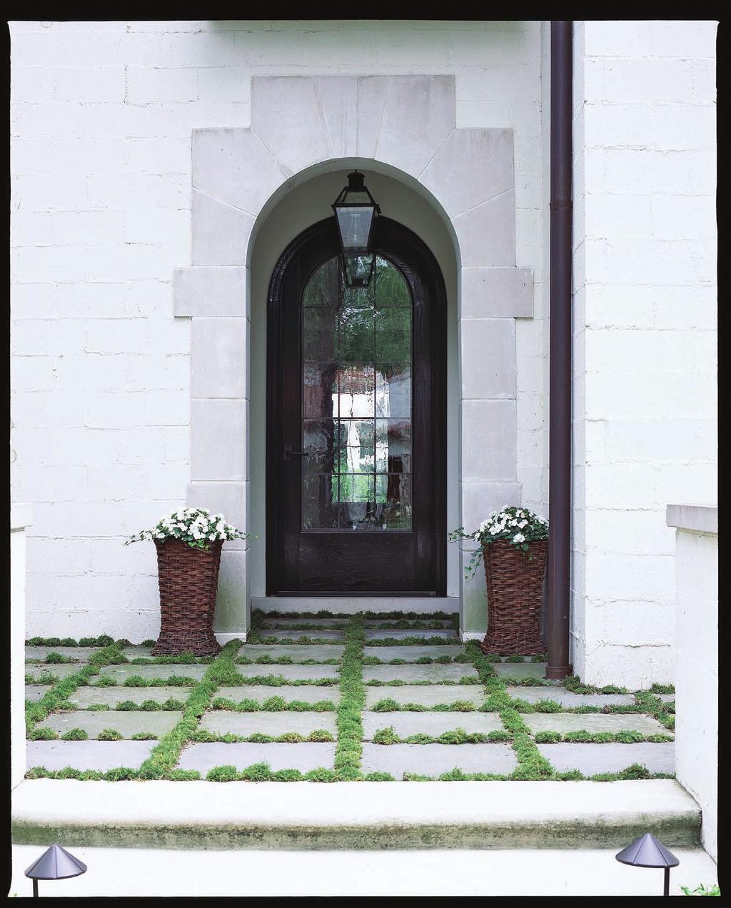 THIS PHOTO Hand-cut limestone accents and willow planters soften the look of the painted concrete cinder block.