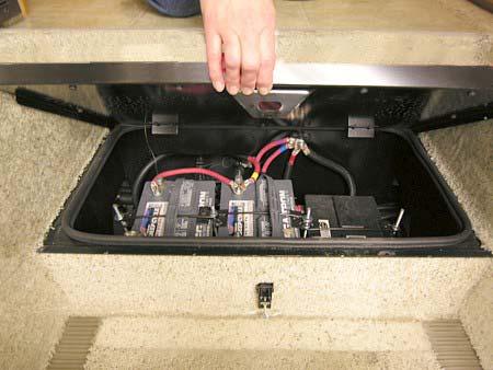 Unfasten the step retainer, then lift the step upward and remove to service batteries. Squeeze tab upward to release latch -Typical View CAUTION Step cover must be closed and latched.