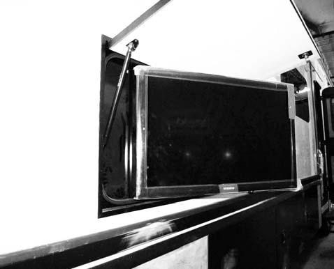 entrance of precipitation. -Typical View 1. Pull the black strap (located on back side of TV) straight down to release the TV from the mounting bracket. -Typical View 2.