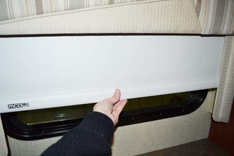 Lower Roller Shade by grasping the bottom center of the shade and pulling straight down by hand.