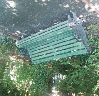 The provision of furniture in central park area is minimal, consisting of several wooden benches, painted green with decorative wrought-iron armrests, and modern litterbins. 3.