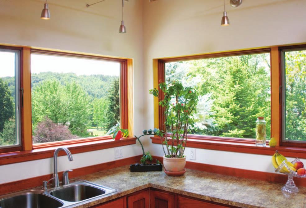 The windows are open to the surrounding views, and Patty considers them photographs of beautiful woods. From the existing structure, the kitchen and dining room were redesigned for simple efficiency.