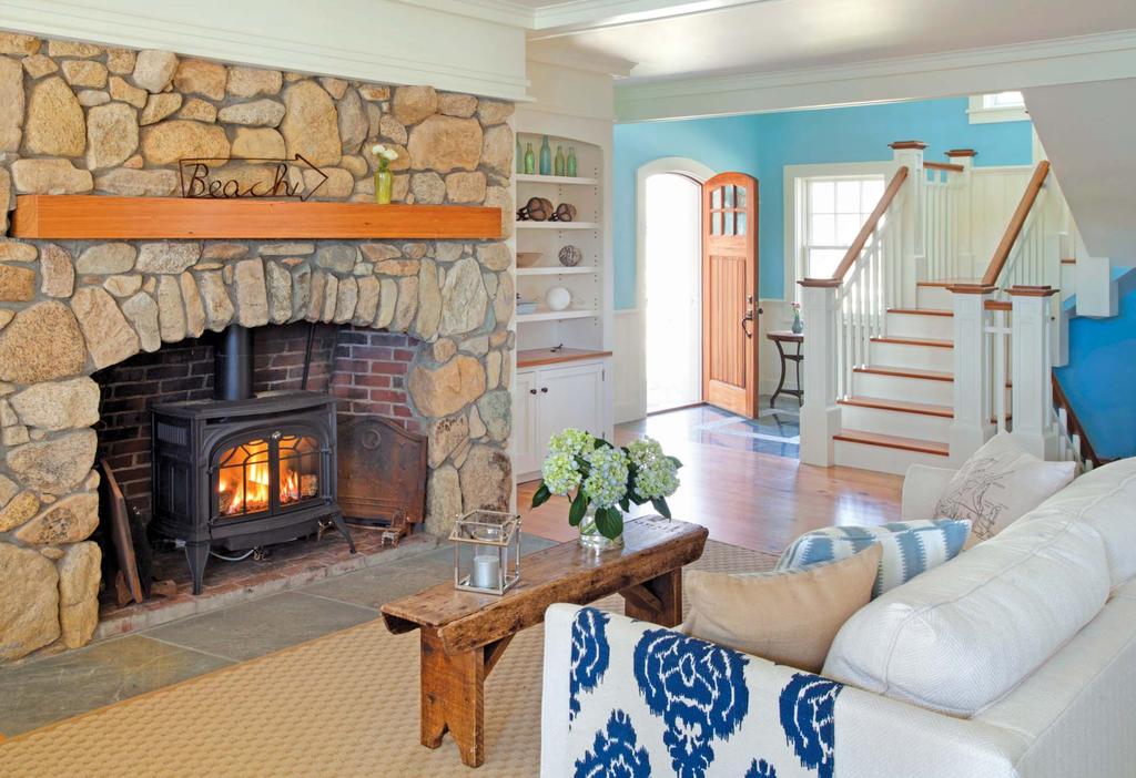 The stone fireplace with woodburning stove emits warmth and comfort on