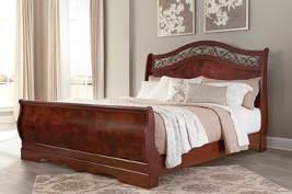 reddish brown finish with replicated cherry grain frames and faux burl fronts Serpentine shaped panel in sleigh footboard Large decorative hardware features fluting and acanthus leaf
