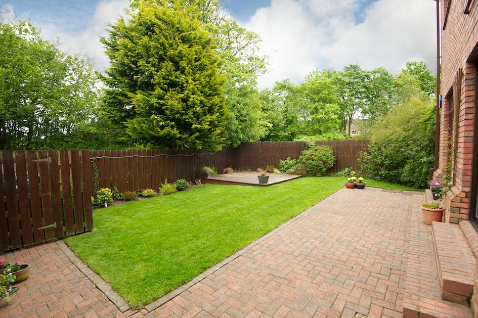 FRONT GARDEN: In lawn with border beds, plants and shrubs. Path to side with further lawn, feature brick wall and more plants and shrubs. Gate to rear.