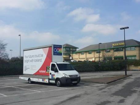 A van with a billboard advertising store vacancies in buying, food technology, marketing and retail at Iceland, was parked outside the soon to be closed down Tesco HQ in Cheshunt today (21 st April