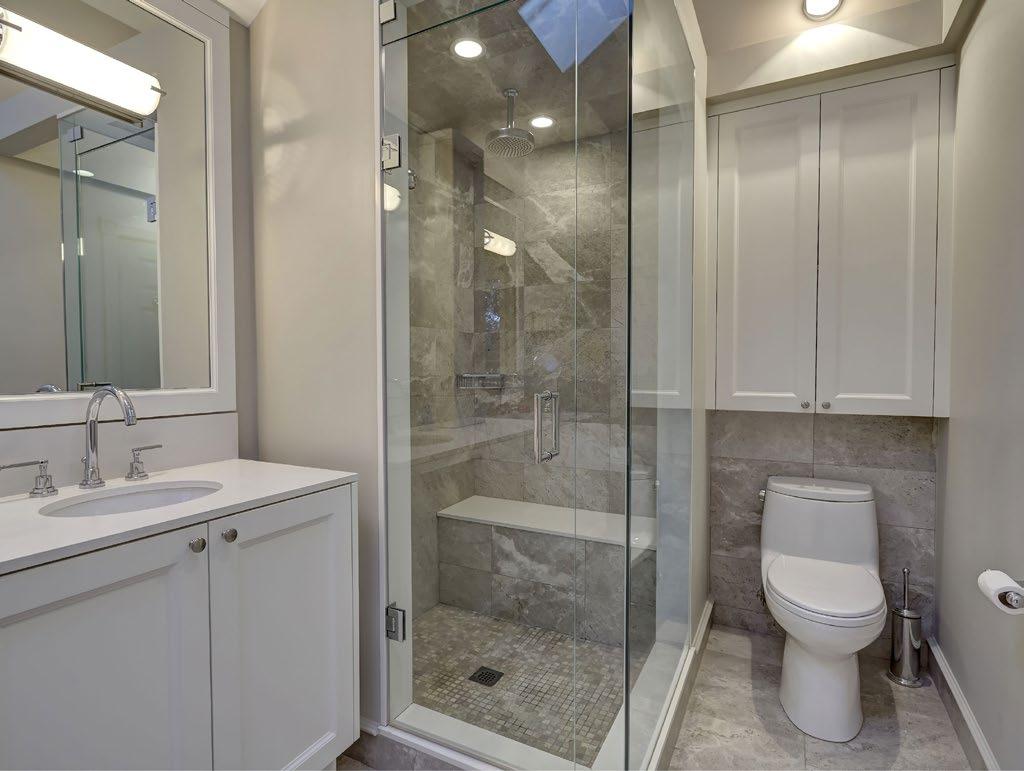 LEFT The glass shower makes the bathroom appear visually larger. BELOW The en suite bathroom was enlarged and includes a soaker tub, steam shower and heated floors.