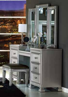 A stylish mirrored vanity, with coordinating stool, provides additional function to the collection. Providing contrast to finish is the dark gray bi-cast vinyl, button-tufted headboard panel.