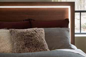 The headboard is illuminated by a LED backed panel and mirror accent that defines the center profile.