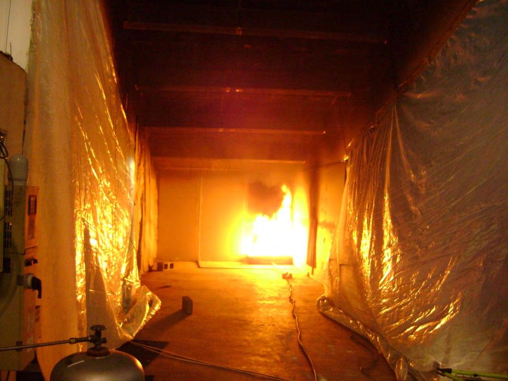 Figure 128. Corner fire test with beamed ceilings and full side walls The greater entrainment of the corner caused the flames to reach an even higher height than the side fire tests.