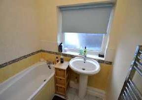 Bathroom Side aspect with a double glazed frosted glass window, the bathroom comprises a panel enclosed bath with mixer tap and independent thermostatic shower above with glazed shower screen,