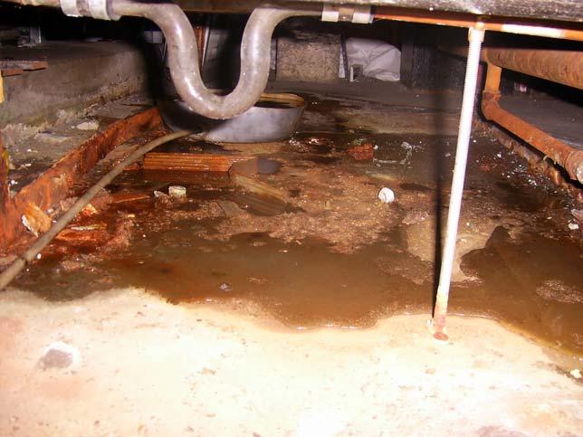 Air Handling Unit plant room showing debris and water ponding on plant