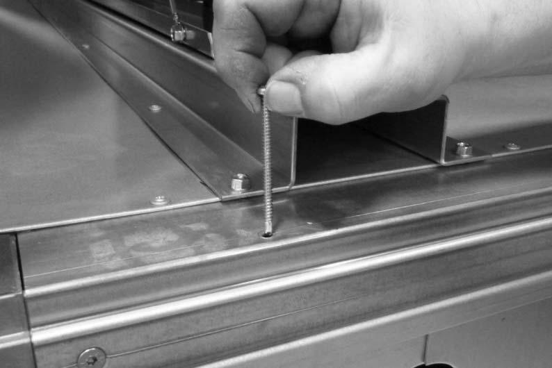 Sections are mounted to base frames with long self drilling screws.
