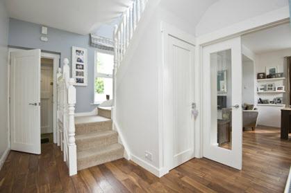Internal door to: RECEPTION HALL: Walnut flooring, cupboard under