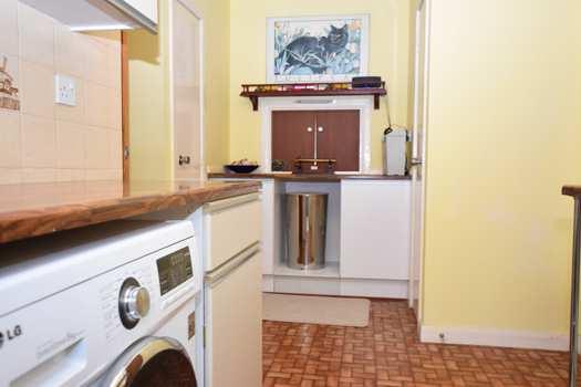 There is plumbing for a washing machine and dishwasher with room for a separate tumble dryer as well as a sink with tiled