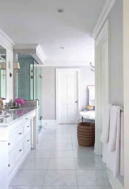 The hardwired folded sconce is from Global Views. The vanity in the master bathroom is a custom design by the architect Judith Larson and the polished nickel sconce is from Visual Comfort.