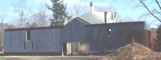 The southeast and southwest sides of the tank are glazed with double low E glass, however, in the house the tank is clad in black tiles, radiating heat in the winter into the living